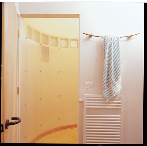 Baths awash in color and natural materials include the master bath, whose circular shower is lined in recyclable plastic sheeting.
